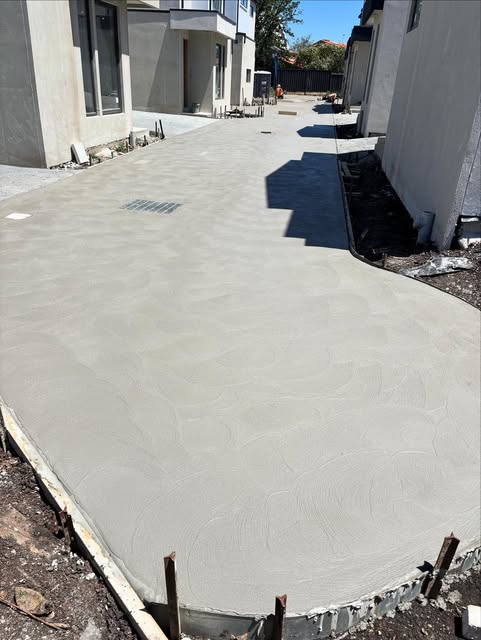 Freshly finished concrete path between townhouses