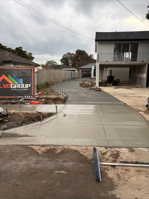 Long curved concrete driveway freshly poured
